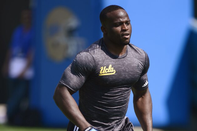 Defensive lineman Owamagbe Odighizuwa runs through drills for NFL football scouts during UCLA's pro day at Spaulding Field in Los Angeles on Tuesday, March 10, 2015. (AP Photo/Kelvin Kuo)