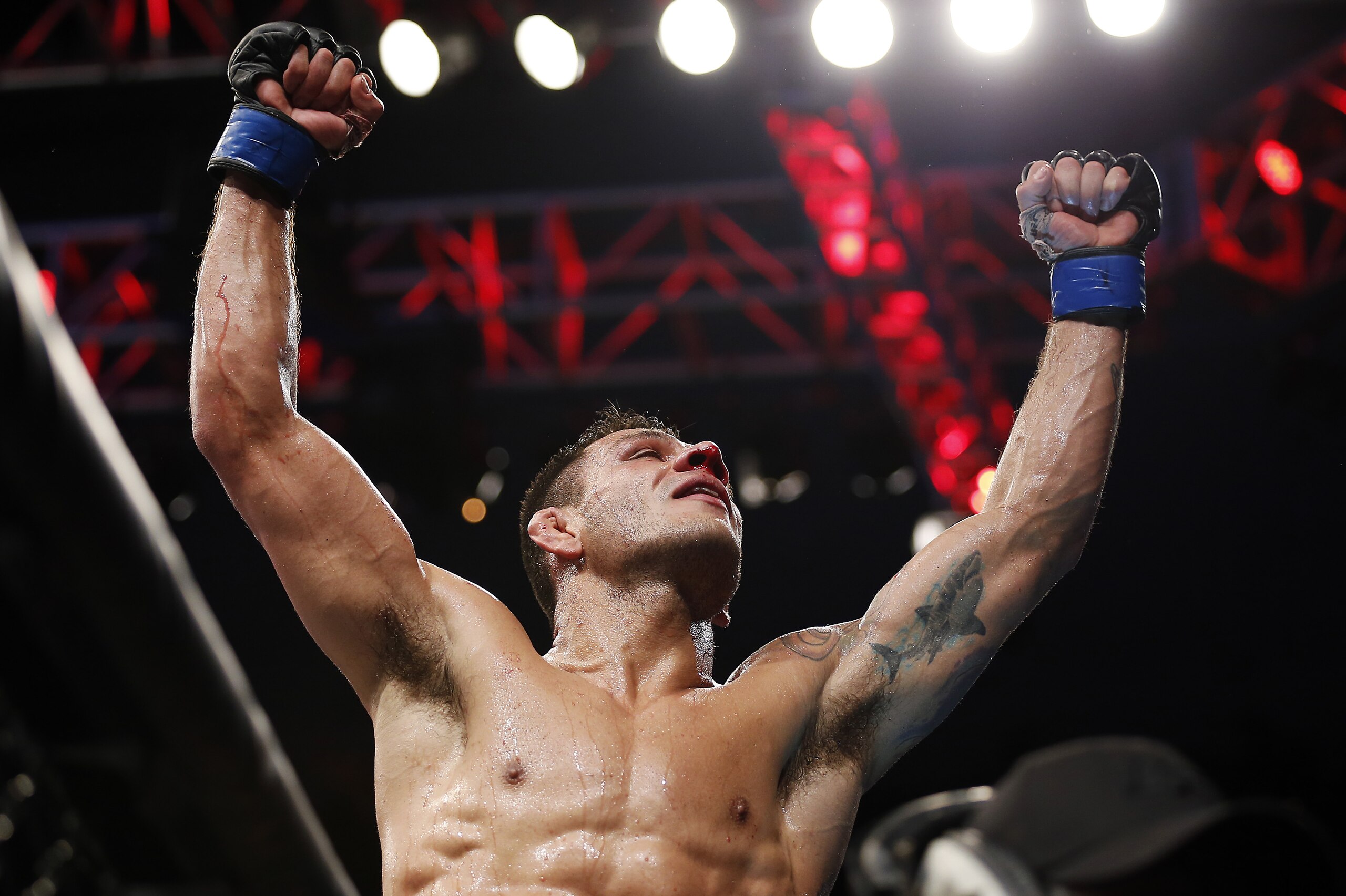 Rafael dos Anjos celebrates winning the men's lightweight mixed martial arts title bout against Anthony Pettis at UFC 185, early Sunday, March 15, 2015, in Dallas. (AP Photo/Brandon Wade)