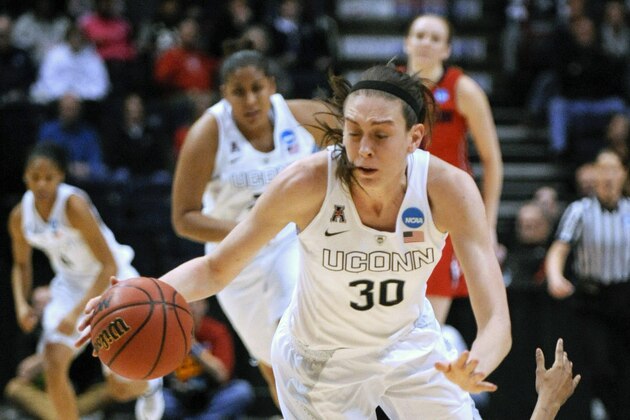 Connecticut forward Breanna Stewart (30) gets tripped by Dayton center Saicha Grant-Allen during the second half of a regional final game in the NCAA women's college basketball tournament on Monday, March 30, 2015, in Albany, N.Y. UConn won 91-70. (AP Photo/Tim Roske)