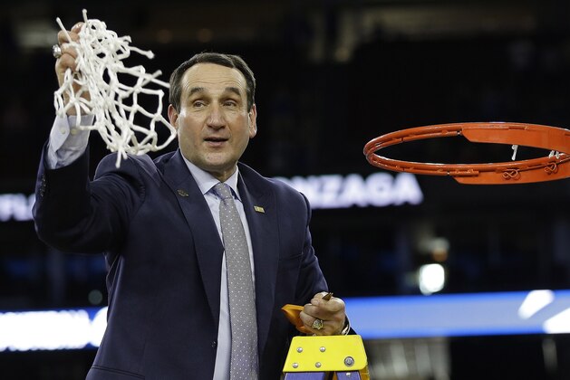 Duke head coach Mike Krzyzewski cuts down the net after a college basketball regional final game against Gonzaga in the NCAA Tournament Sunday, March 29, 2015, in Houston. Duke won 66-52 to advance to the Final Four. (AP Photo/David J. Phillip)
