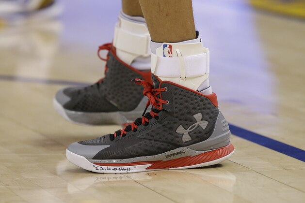 Golden State Warriors guard Stephen Curry's shoes are shown during the second half of an NBA basketball game against the Houston Rockets in Oakland, Calif., Wednesday, Jan. 21, 2015. (AP Photo/Jeff Chiu)
