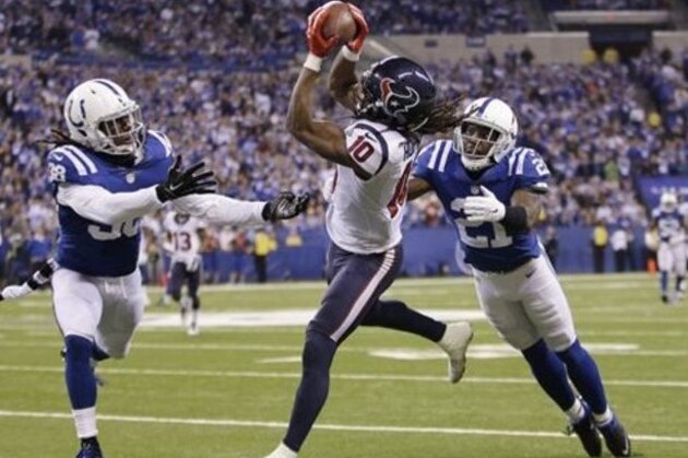Houston Texans wide receiver DeAndre Hopkins, center, is unable to hold on to a pass between Indianapolis Colts free safety Sergio Brown, left, and cornerback Vontae Davis during the second half of an NFL football game in Indianapolis, Sunday, Dec. 14, 2014. The Colts defeated the Texans 17-10. (AP Photo/AJ Mast)