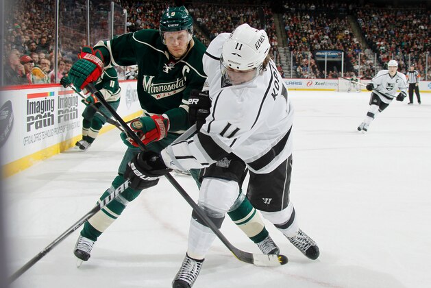ST. PAUL, MN - MARCH 30: Anze Kopitar #11 of the Los Angeles Kings and Mikko Koivu #9 of the Minnesota Wild battle for the puck during the game on March 30, 2013 at the Xcel Energy Center in Saint Paul, Minnesota. (Photo by Bruce Kluckhohn/NHLI via Getty Images)