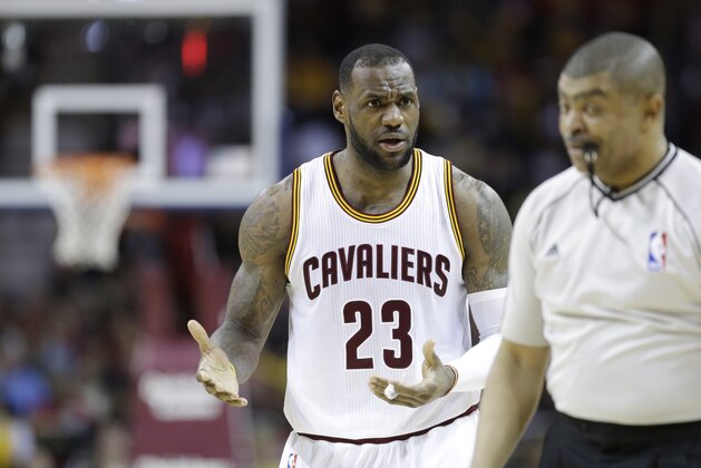 Cleveland Cavaliers' LeBron James (23) complains to referee Tony Brothers about a traveling call in the second half of an NBA basketball game Sunday, March 29, 2015, in Cleveland. (AP Photo/Mark Duncan)