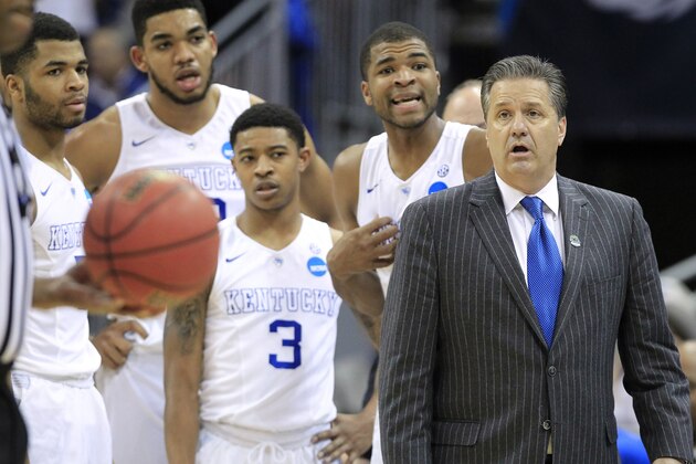 Kentucky guard Aaron Harrison, second from right, and head coach John Calipari listen to the official's explanation of a technical foul called on Harrison during the second half of an NCAA tournament college basketball game against Cincinnati in Louisville, Ky., Saturday, March 21, 2015. Kentucky won the game 64-51. (AP Photo/David Stephenson)