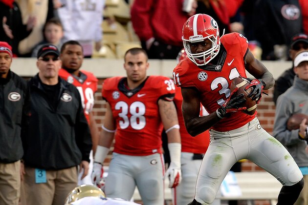 Georgia's Chris Conley (31) makes the first down reception in front of Georgia Tech's Louis Young during the first half of an NCAA football game on Saturday, Nov. 30, 2013, in Atlanta. Georgia Tech built a 20-7 halftime lead over Georgia. (AP Photo/David Tulis)