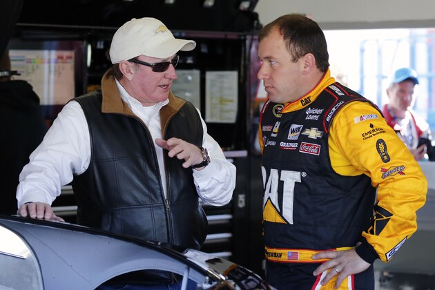 Car owner Richard Childress, left, talks with driver Ryan Newman in their garage while crew members work on the car engine during a practice session for the Daytona 500 NASCAR Sprint Cup Series auto race at Daytona International Speedway, Saturday, Feb. 14, 2015, in Daytona Beach, Fla. (AP Photo/Terry Renna)