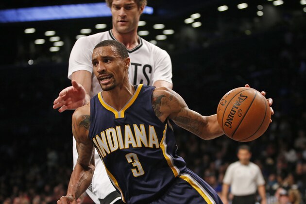 Brooklyn Nets center Brook Lopez (11) defends Indiana Pacers guard George Hill (3) in the second half of an NBA basketball game at the Barclays Center, Tuesday, March 31, 2015, in New York. The Nets defeated the Pacers 111-106. (AP Photo/Kathy Willens)