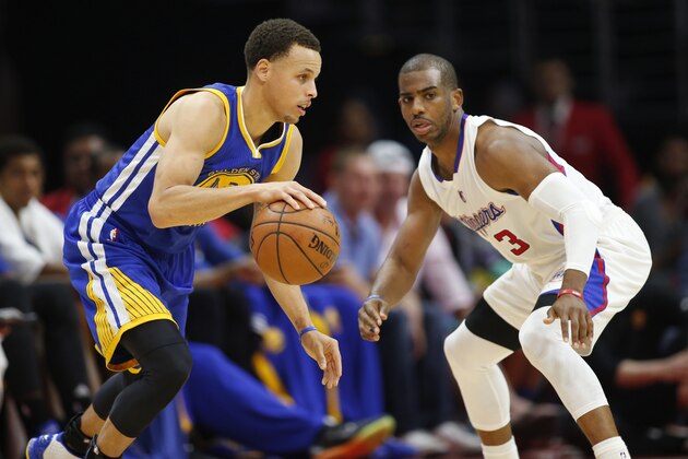 Golden State Warriors' Stephen Curry, left, dribbles while Los Angeles Clippers Chris Paul, right, defends him during the first half of an NBA basketball game, Tuesday, March 31, 2015, in Los Angeles. (AP Photo/Danny Moloshok)