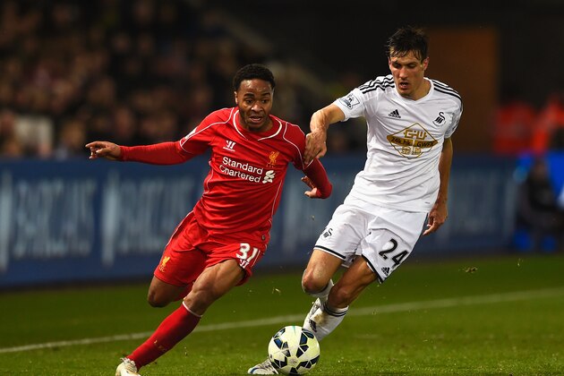 SWANSEA, WALES - MARCH 16: Raheem Sterling of Liverpool takes on Jack Cork of Swansea City during the Barclays Premier League match between Swansea City and Liverpool at Liberty Stadium on March 16, 2015 in Swansea, Wales.  (Photo by Mike Hewitt/Getty Images)