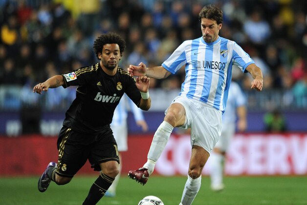 MALAGA, SPAIN - JANUARY 10:  Ruud van Nistelrooy (R) of Malaga duels for the ball with Marcelo of Real Madrid during the round of 16 Copa del Rey second leg match between Malaga and Real Madrid at La Rosaleda Stadium on January 10, 2012 in Malaga, Spain.  (Photo by Jasper Juinen/Getty Images)