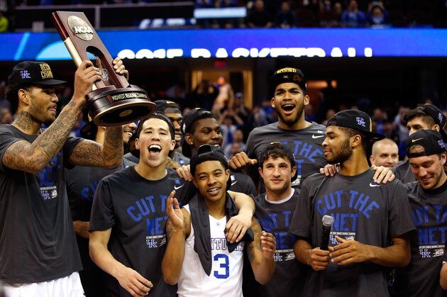 CLEVELAND, OH - MARCH 28: the Kentucky Wildcats celebrate with their trophy after defeating the Notre Dame Fighting Irish during the Midwest Regional Final of the 2015 NCAA Men's Basketball tournament at Quicken Loans Arena on March 28, 2015 in Cleveland, Ohio. Kentucky defeated Notre Dame 68-66.  (Photo by Gregory Shamus/Getty Images)