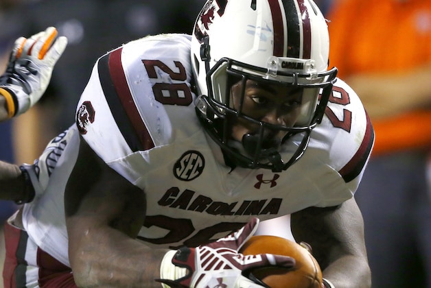 South Carolina's Mike Davis dives for a touchdown as Auburn defensive back Jonathon Mincy (6) tires to tackle him during the first half of an NCAA college football game on Saturday, Oct. 25, 2014, in Auburn, Ala. (AP Photo/Butch Dill)