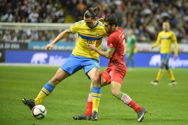 Sweden's Zlatan Ibrahimovic, left, battles for the ball with Iran's Vahid Amiri during their international friendly soccer match at in Stockholm, Sweden, Tuesday March 31, 2015. (AP Photo/Henrik Montgomery, TT) **  SWEDEN OUT  **