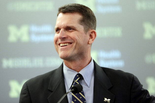 Jim Harbaugh, Michigan's new head football coach, addresses the media after after he was introduced during an NCAA college football news conference Tuesday, Dec. 30, 2014, in Ann Arbor, Mich. (AP Photo/Carlos Osorio)