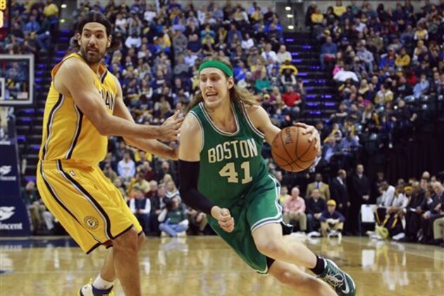 Boston Celtics center Kelly Olynyk (41) drives on Indiana Pacers forward Luis Scola in the second half of an NBA basketball game in Indianapolis, Friday, Jan. 9, 2015. Indiana won 107-103. (AP Photo/R Brent Smith)