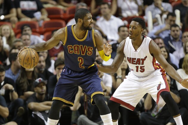 Cleveland Cavaliers' Kyrie Irving (2) is defended by Miami Heat's Mario Chalmers (15) during the first half of an NBA basketball game, Monday, March 16, 2015, in Miami. (AP Photo/Lynne Sladky)