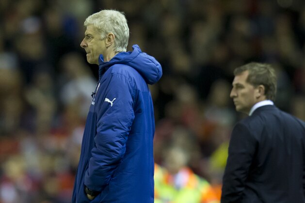 Arsenal's manager Arsene Wenger, left, stands alongside Liverpool's manager Brendan Rodgers during the English Premier League soccer match between Liverpool and Arsenal at Anfield Stadium, Liverpool, England, Sunday Dec. 21, 2014. (AP Photo/Jon Super)