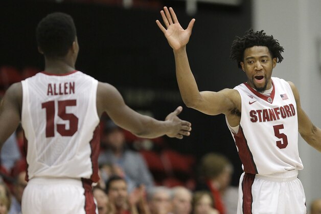 Stanford's Marcus Allen (15) and Chasson Randle (5) celebrates during the second half of an NCAA college basketball game in the National Invitation Tournament against Vanderbilt in Stanford, Calif., Tuesday, March 24, 2015. Stanford won 78-75. (AP Photo/Jeff Chiu)