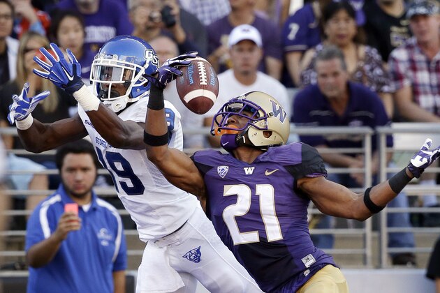 Washington's Marcus Peters (21) snags the ball in the end zone in front of intended receiver Georgia State's Robert Davis in the first half of an NCAA college football game Saturday, Sept. 20, 2014, in Seattle. Peters was flagged for pass interference on the play, leading to a Georgia State touchdown on the drive. (AP Photo/Elaine Thompson)