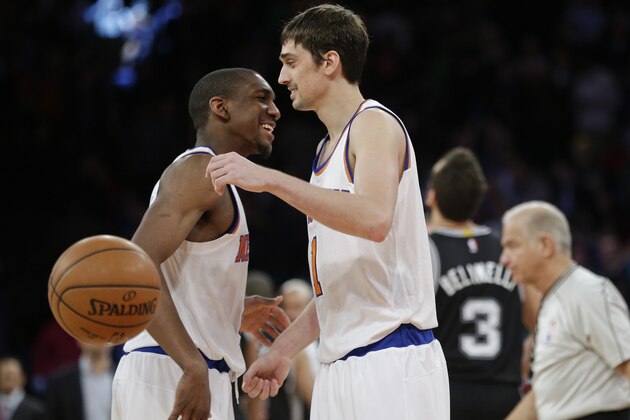 New York Knicks' Alexey Shved, right, and teammate Langston Galloway, left, celebrate during the overtime period of an NBA basketball game against the San Antonio Spurs Tuesday, March 17, 2015, in New York. The Knicks won the game 104-100. (AP Photo/Frank Franklin II)