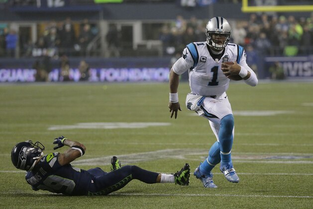Carolina Panthers quarterback Cam Newton (1) runs against Seattle Seahawks free safety Earl Thomas (29) during the second half of an NFL divisional playoff football game in Seattle, Saturday, Jan. 10, 2015. (AP Photo/Ted S. Warren)