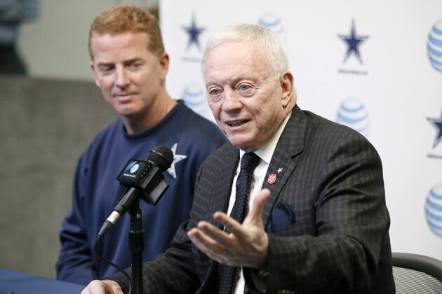 Dallas Cowboys team owner Jerry Jones, front, responds to questions about head coach Jason Garrett's, left, five year contract extension during a news conference at the teams headquarters, Thursday, Jan. 15, 2015, in Irving, Texas. (AP Photo/Tony Gutierrez)