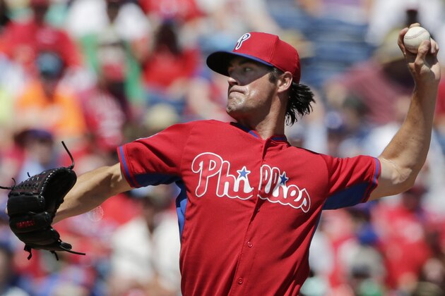 Philadelphia Phillies starting pitcher Cole Hamels winds up in the first inning of a spring training baseball game against the Toronto Blue Jays in Clearwater, Fla., Saturday, March 21, 2015. (AP Photo/Kathy Willens)