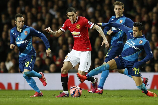Arsenal's Alexis Sanchez, right challenges Manchester United’s Angel Di Maria for the ball during the English FA Cup quarterfinal soccer match between Manchester United and Arsenal at Old Trafford Stadium, Manchester, England, Monday, March 9, 2015. (AP Photo/Jon Super)