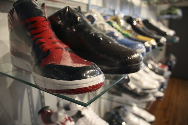 In this photo taken Feb. 28, 2012, limited edition sneakers, wrapped in plastic to protect them, sit in a Chicago consignment store.