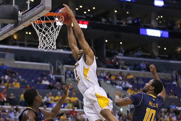 Wichita State guard Tekele Cotton, center, dunks as La Salle's Ramon Galloway, left, and Sam Mills watch during the second half of a West Regional semifinal in the NCAA men's college basketball tournament, Thursday, March 28, 2013, in Los Angeles. (AP Photo/Jae C. Hong)