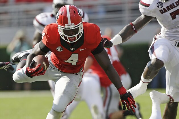 Georgia running back Keith Marshall (4) gets by South Carolina safety Brison Williams (12) during the first half of an NCAA football game, Saturday, Sept. 7, 2013, in Athens, Ga. (AP Photo/John Bazemore)