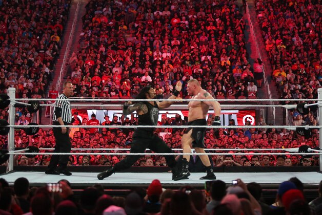 WWE wrestler Roman Reigns throws a punch at Brock Lesnar at Wrestlemania XXXI, on Sunday, March 29, 2015 in Santa Clara, CA. 2015 marks the first year Wrestlemania will be held in the San Francisco Bay Area, being made available to viewers in 177 countries via the WWE Network. (Don Feria/AP Images for WWE)