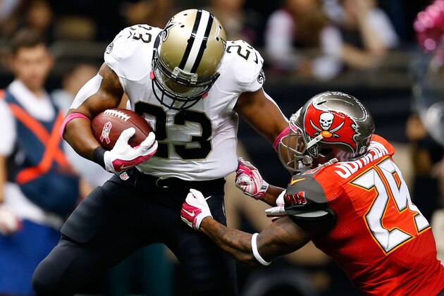 NEW ORLEANS, LA - OCTOBER 05:  Pierre Thomas #23 of the New Orleans Saints breaks a tackle by Leonard Johnson #29 of the Tampa Bay Buccaneers during the fourth quarter of a game at the Mercedes-Benz Superdome on October 5, 2014 in New Orleans, Louisiana.  (Photo by Wesley Hitt/Getty Images)