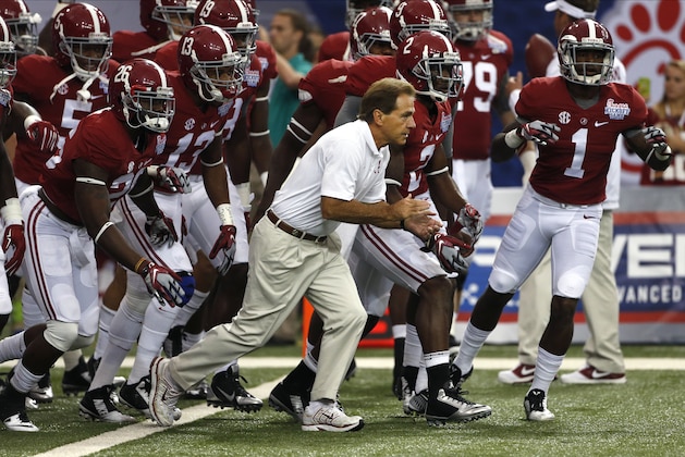 Alabama head coach Nick Saban and the Crimson Tide take the field to warm up up before an NCAA college football game against West Virginia Saturday, Aug. 30, 2014, in Atlanta.  (AP Photo/John Bazemore)