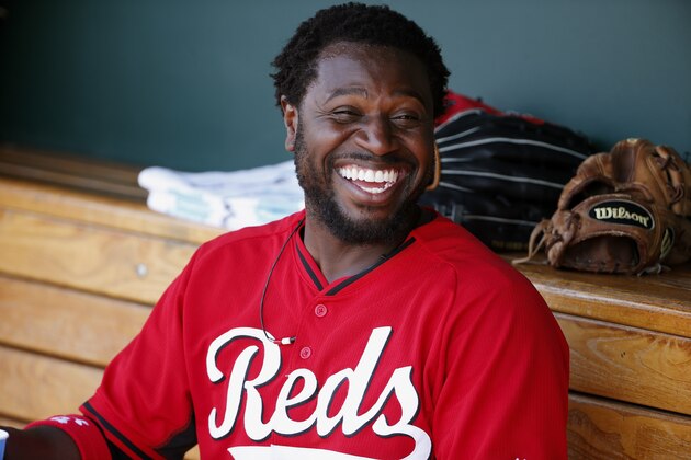 Cincinnati Reds' Brandon Phillips laughs in the dugout as he jokes around with teammates during the second inning of a spring training baseball game Wednesday, April 1, 2015, in Goodyear, Ariz.  The Diamondbacks defeated the Reds 3-0. (AP Photo/Ross D. Franklin)