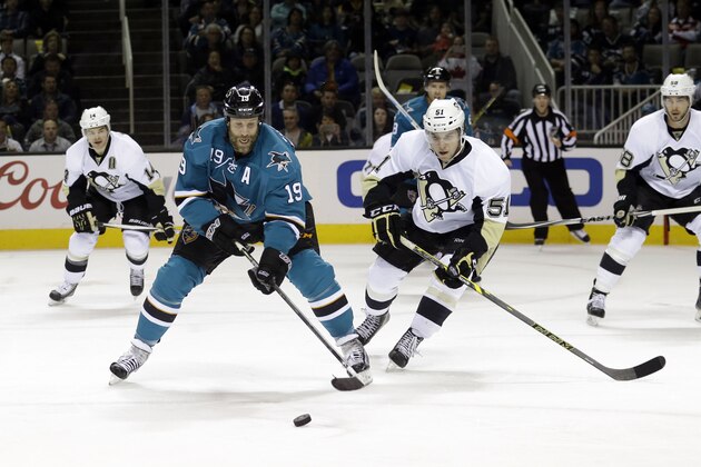 San Jose Sharks' Joe Thornton (19) controls the puck next to Pittsburgh Penguins' Derrick Pouliot (51) during the first period of an NHL hockey game Monday, March 9, 2015, in San Jose, Calif. (AP Photo/Marcio Jose Sanchez)