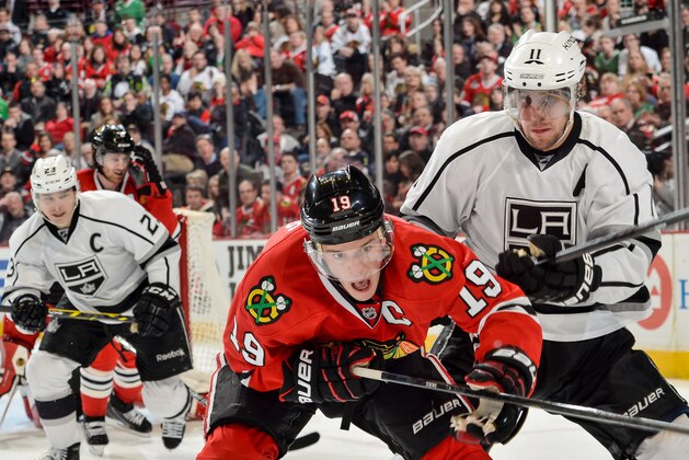 CHICAGO, IL - MARCH 30:  Anze Kopitar #11 of the Los Angeles Kings pushes into Jonathan Toews #19 of the Chicago Blackhawks as Dustin Brown #23 skates behind during the NHL game at the United Center on March 30, 2015 in Chicago, Illinois.  (Photo by Bill Smith/NHLI via Getty Images)