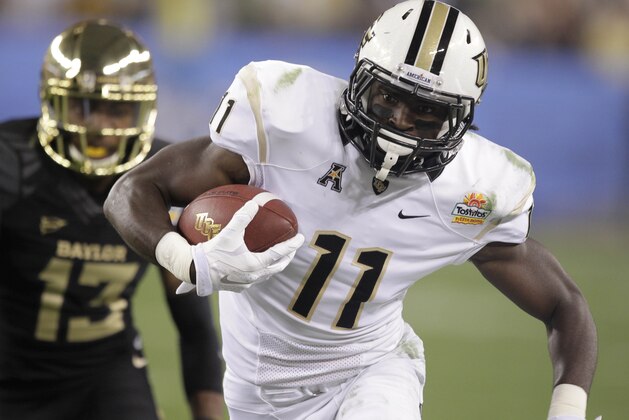 Central Florida wide receiver Breshad Perriman (11) makes a catch as Baylor safety Terrell Burt (13) pursues during the first half of the Fiesta Bowl NCAA college football game, Wednesday, Jan. 1, 2014, in Glendale, Ariz.  (AP Photo/Rick Scuteri)
