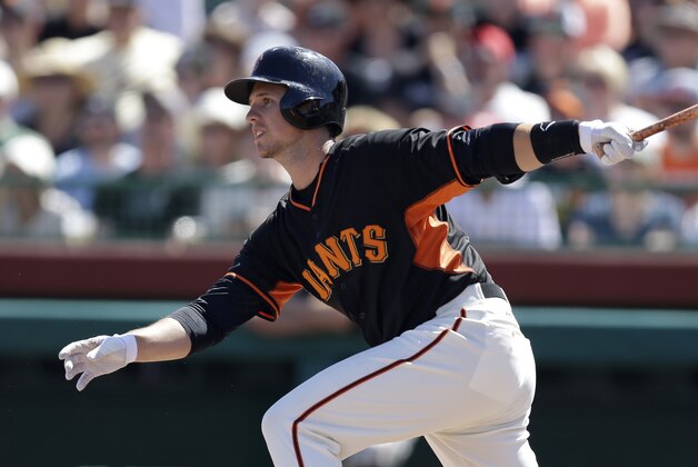 San Francisco Giants' Buster Posey swings for a double off Kansas City Royals' Edinson Volquez in the first inning of a spring training exhibition baseball game Monday, March 23, 2015, in Scottsdale, Ariz. (AP Photo/Ben Margot)