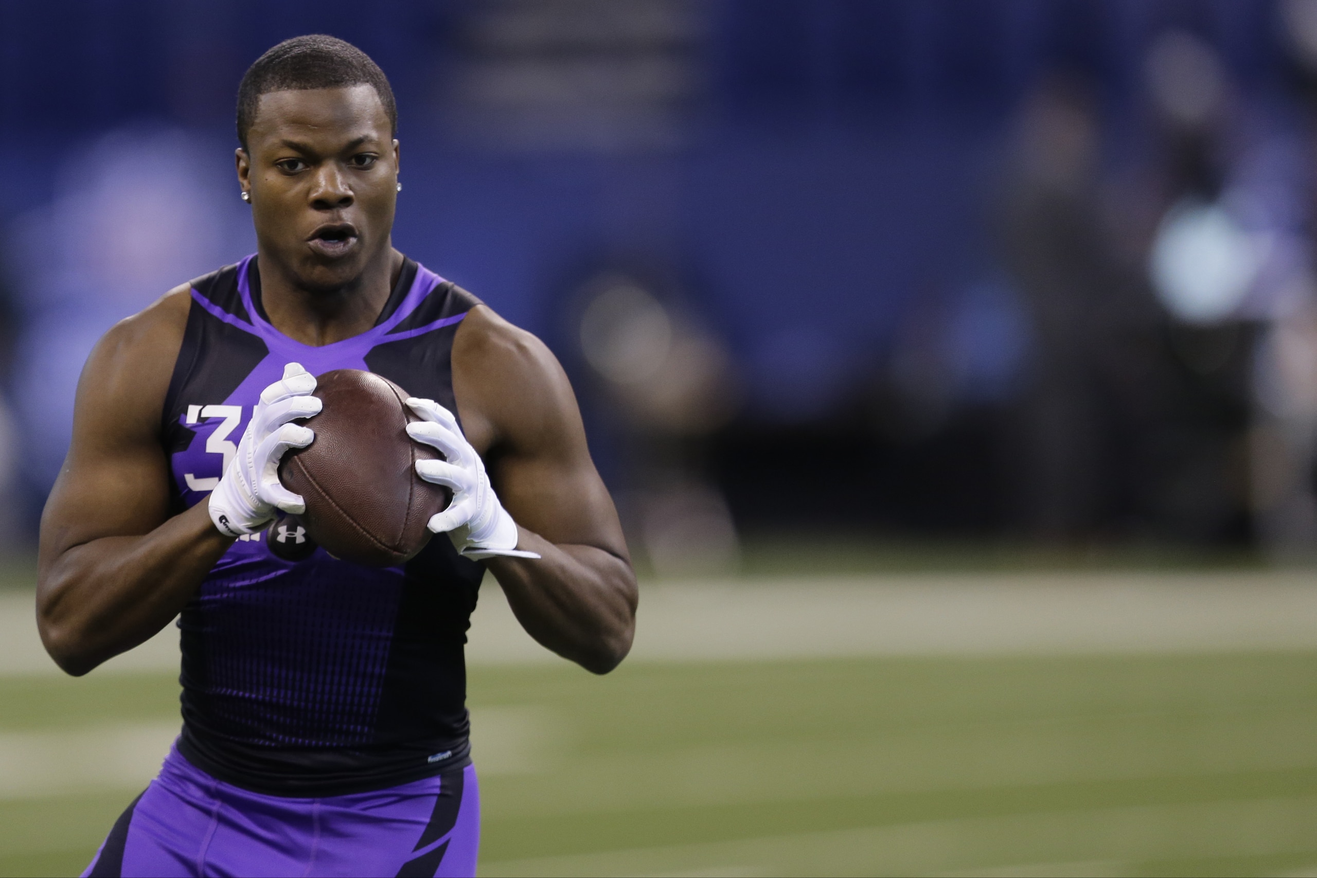 Washington defensive back Marcus Peters runs a drill at the NFL football scouting combine in Indianapolis, Monday, Feb. 23, 2015. (AP Photo/Julio Cortez)