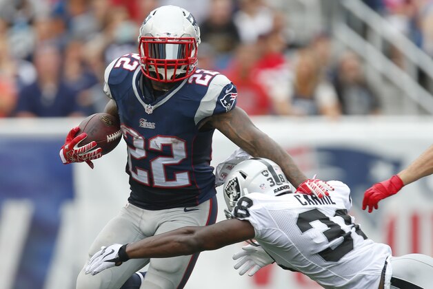 New England Patriots running back Stevan Ridley (22) breaks a tackle by Oakland Raiders cornerback T.J. Carrie (38) during an NFL game at Gillette Stadium in Foxborough, Mass. on Sunday, Sept. 21, 2014 . (Chris Keane/AP Images for Panini)
