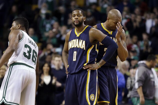 Indiana Pacers guard C.J. Miles (0) and forward David West, right, react late in the fourth quarter of an NBA basketball game against the Boston Celtics in Boston Wednesday, April 1, 2015. At left is Boston Celtics guard Marcus Smart. The Celtics won 100-87. (AP Photo/Elise Amendola)