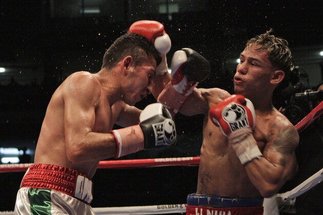 Mexico's Omar Salado, left, and Panama's Luis Concepcion, right, battle during their World Boxing Association interim flyweight title fight in Panama City, Saturday, Sept. 5, 2009. Concepcion won by technical KO during the 12th round. (AP Photo/Arnulfo Franco)