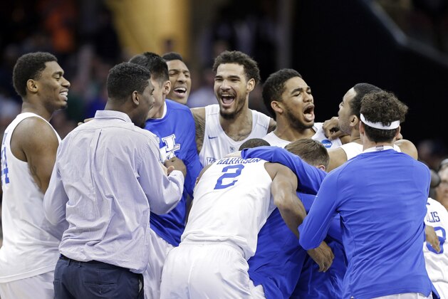 Kentucky players celebrate after a 68-66 win over Notre Dame in a college basketball game in the NCAA men's tournament regional finals, Saturday, March 28, 2015, in Cleveland. The 38-0 Wildcats advanced to the Final Four. (AP Photo/Tony Dejak)