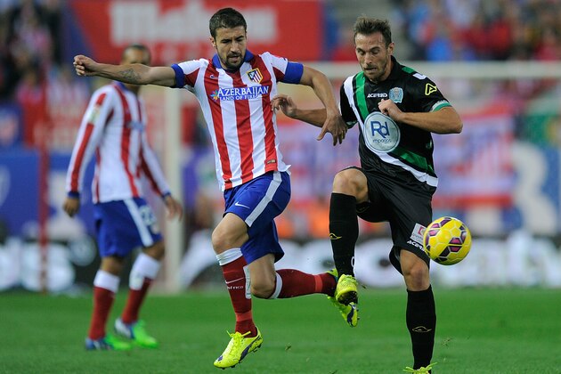 MADRID, SPAIN - NOVEMBER 01:  Gabi Fernandez of Club Atletico de Madrid battles for the ball against Lopez Garai of Cordoba CF during the La Liga match between Club Atletico de Madrid and Cordoba CF at Vicente Calderon Stadium on November 1, 2014 in Madrid, Spain.  (Photo by Denis Doyle/Getty Images)