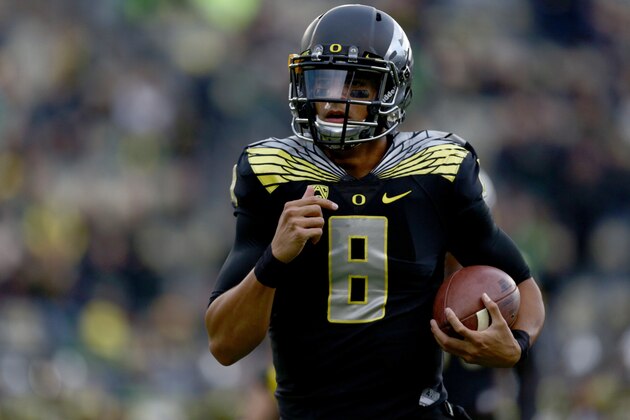 Oregon quarterback Marcus Mariota (8) runs the ball before an NCAA college football game against Stanford in Eugene, Ore., Saturday, Nov. 1, 2014. (AP Photo/Ryan Kang)