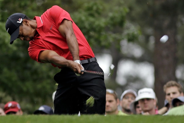 Tiger Woods tees off on the fourth hole during the fourth round of the Masters golf tournament Sunday, April 14, 2013, in Augusta, Ga. (AP Photo/Matt Slocum)