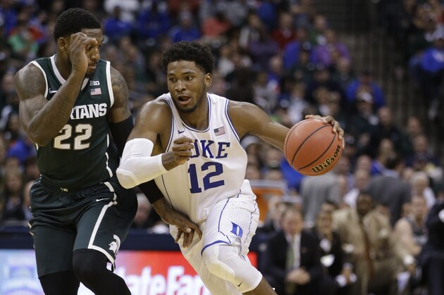 Duke's Justise Winslow (12) id defended by Michigan State's Branden Dawson (22) during the second half of an NCAA college basketball game Tuesday, Nov. 18, 2014, in Indianapolis. Duke won 81-71. (AP Photo/Darron Cummings)