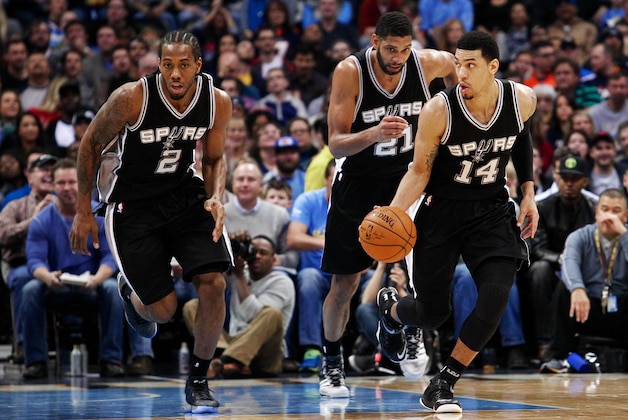 Dec 14, 2014; Denver, CO, USA; San Antonio Spurs guard Danny Green (14) dribbles the ball up court with forward Kawhi Leonard (2) and forward Tim Duncan (21) in the third quarter against the Denver Nuggets at Pepsi Center. The San Antonio Spurs defeated the Denver Nuggets 99-91. Mandatory Credit: Isaiah J. Downing-USA TODAY Sports